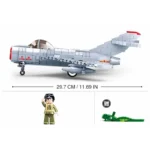 A gray toy airplane, a toy figure wearing a green uniform, and a green toy crocodile are displayed.