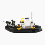 A toy boat with a figure holding a rifle stands on a black base with yellow and red elements.
