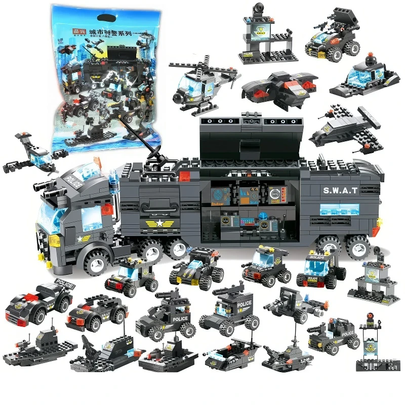 A collection of black and gray toy vehicles, including a large truck, helicopters, cars, and boats, are displayed.