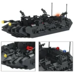 A black brick toy boat with mounted guns and lights is displayed.