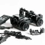 A black toy vehicle, a shield, and several toy guns are displayed.