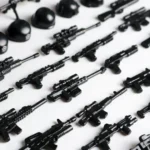 Black toy rifles and helmets are arranged in rows.