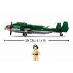 A green toy airplane and a pilot figure are displayed with a measurement line.