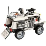 White and gray toy vehicle with a mounted gun and a ramp on the back.