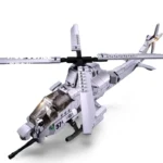 A gray toy helicopter with a rotating rotor and a gun is visible.