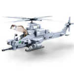 A gray toy helicopter with a rotating propeller, a cockpit, and weapons is displayed.