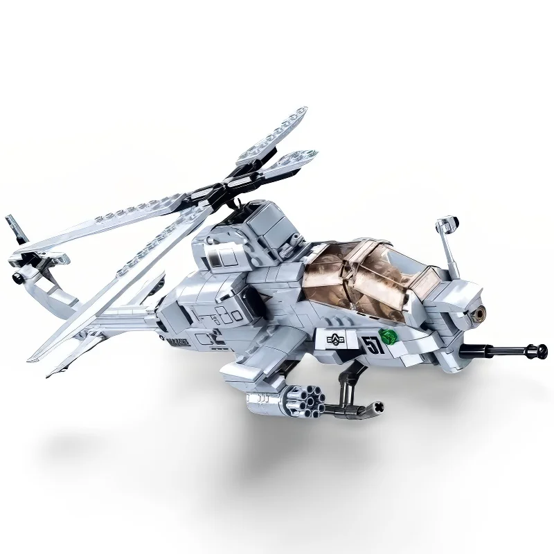 A gray toy helicopter with black rotors and a transparent cockpit is displayed.