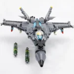 A gray toy jet with two green bombs underneath.