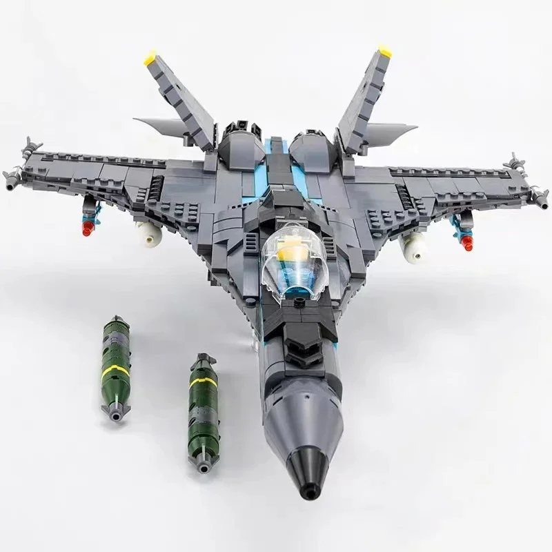 A gray toy jet with two green bombs underneath.