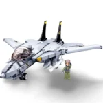 A gray toy jet with black fins and a pilot figure in green uniform are displayed.