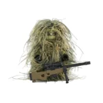 A toy figure wearing a ghillie suit holds a rifle.