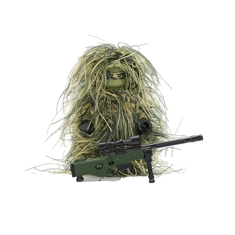 A toy figure wearing a ghillie suit holds a green sniper rifle.