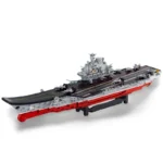 A gray and red toy aircraft carrier with several small planes on the deck.