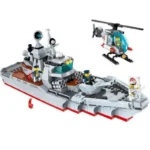 A toy warship with three figures and a helicopter are visible.