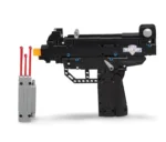 A black toy gun with a gray magazine holding three red projectiles.