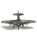 A toy airplane with green, tan, and gray blocks, a red propeller, and yellow bombs.