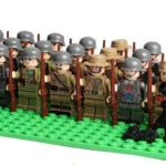 A group of toy soldier figures with helmets and rifles stand on a green base.