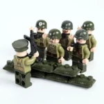 Six toy figures in military uniforms stand behind sandbag barriers, one holding a black rifle.